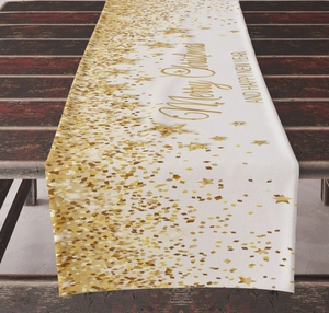 Close-up of beige linen Christmas table runner with golden Merry Christmas lettering