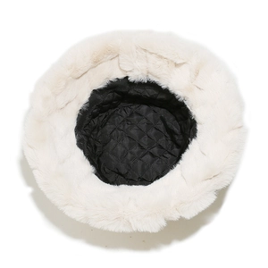 Close-up of black quilted lining and white faux fur brim on winter bucket hat
