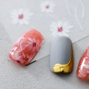 Artistic nail stickers with cherry blossoms, matte grey finish, and 3D gold relief textures