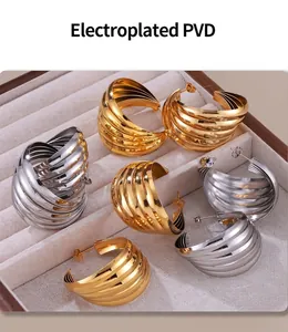 Detail of PVD plated multi-layer textured hoop earrings in gold and silver finish