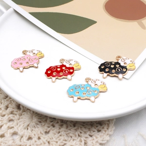 Detailed view of colorful sheep charms in pink, red, black and blue for DIY jewelry