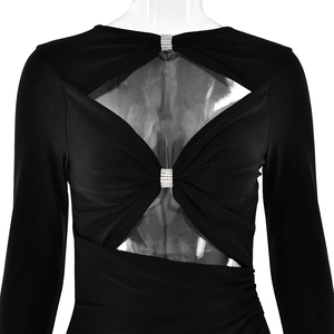 Close-up of black long sleeve dress with sexy hollow-out chest and shiny decorative buckles