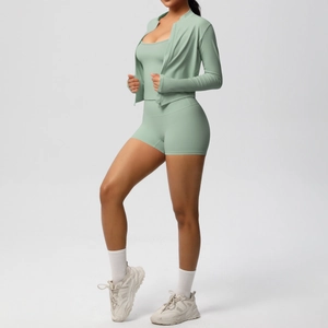 Three-piece mint green yoga set with zipper jacket, camisole top, and high-waist shorts