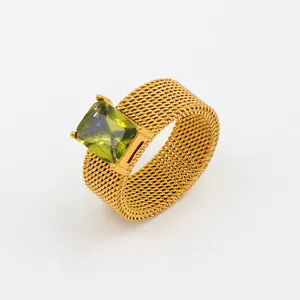 Close-up of square emerald green zircon inlaid on golden mesh stainless steel ring