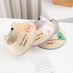 Detail of kids straw sun visors with cartoon animal patterns and sweet lettering