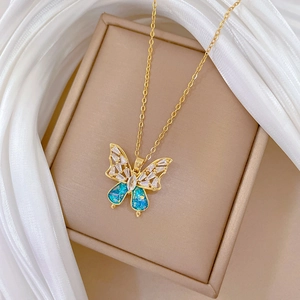 Detailed close-up of a blue butterfly pendant necklace on a brown jewelry box