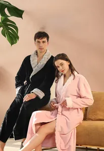 Detail view of thick coral fleece bathrobes for couples in pink and black colors