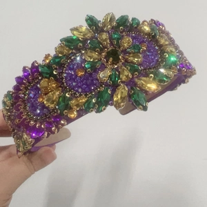 Detail of baroque headband with purple and green crystals in a floral mosaic pattern