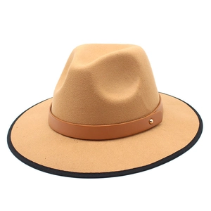 Detail of camel wool fedora with brown leather band and black binding on wide brim