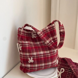 Red plaid canvas handbag with bow embroidery and simple wish label on white tray