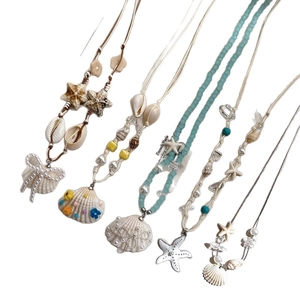 Bohemian wax cord necklace with starfish shell pearl charms for a summer vacation look