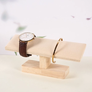 Single T-bar jewelry stand with beige velvet roll and rubber wood base for watches