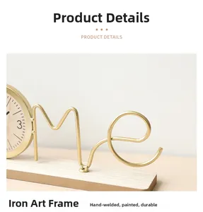 Detailed view of the handcrafted gold iron frame and wooden base of the creative table clock