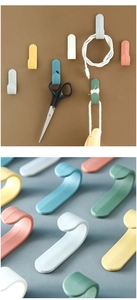 Detailed view of colorful J-shaped hooks for home organization in various matte finishes
