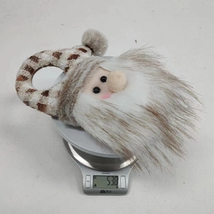 Close-up of Santa Claus plush door hanger weighing 53.8g on a digital kitchen scale