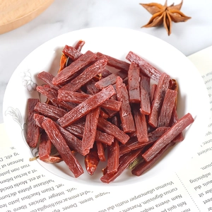 Miniature PVC beef jerky model in a white dish with star anise and chili decorations