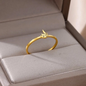 Minimalist gold plated stainless steel ring with a flame design on a jewelry box display