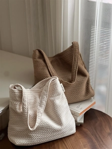 Detailed macro view of woven rice ear texture on beige and brown knit tote bags