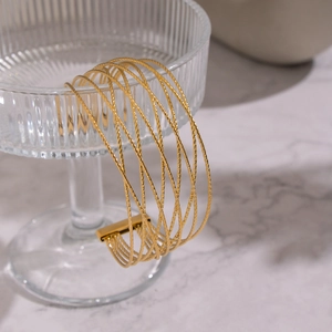 Detailed macro view of the gold multi-layer twisted wire mesh cuff bracelet