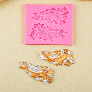 Pink silicone lace flower mold with gold and silver paisley fondant cake decorations