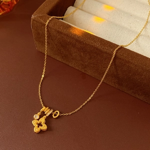 Detailed close-up of 18k gold plated four-leaf clover necklace with sparkling zircon stones