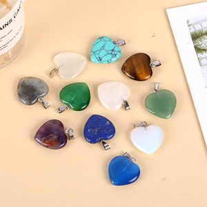 Multiple colorful heart gemstone pendants made of amethyst and turquoise with metal bails