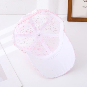 Detail of pink sequins and floral embroidery on breathable white mesh baseball cap