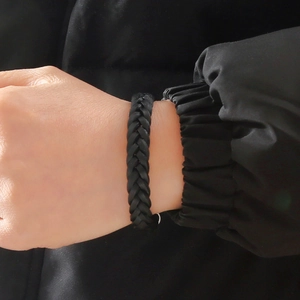 Close-up of a black woven leather bracelet for men with a secure magnetic clasp