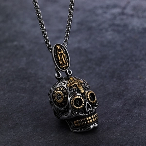 Macro detail of gothic skull pendant with gold cross inlay and vintage metal texture
