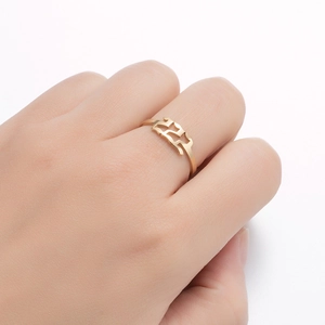 Detail view of gold adjustable ring with 11:11 angel number hollow design worn on finger