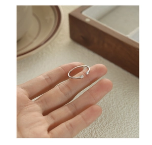 Close-up of cute cat paw silver ring with sparkling rhinestones on model finger