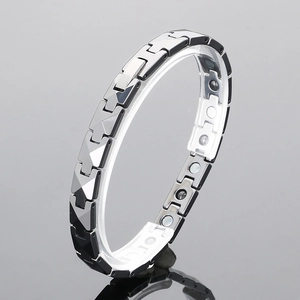 Detail of tungsten steel bracelet featuring magnetic therapy beads and polished links