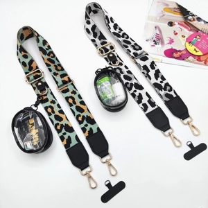 Adjustable leopard print crossbody straps with gold hardware and clear PVC pouches