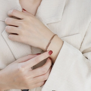 Elegant rose gold Cuban link bracelet with lobster clasp on model wrist