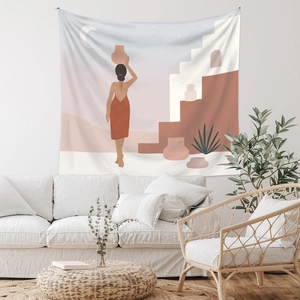 Detail of Bohemian tapestry with desert sun and female silhouette on a living room wall