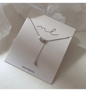 Detail view of S925 silver necklace with white pearl and sparkling zircon pendant