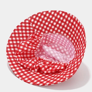 Detail view of red gingham sun hat interior showing adjustable elastic strap and breathable lining