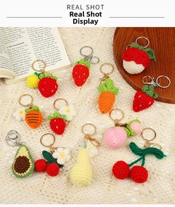 Macro detail of handmade crochet fruit and vegetable keychains with metal clasps