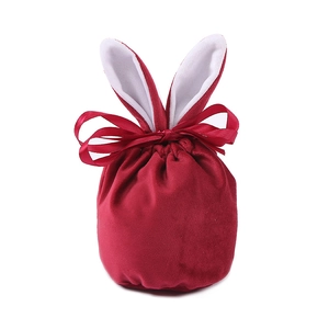 Detailed view of red velvet Easter bunny ear gift bag with a matching silk ribbon bow
