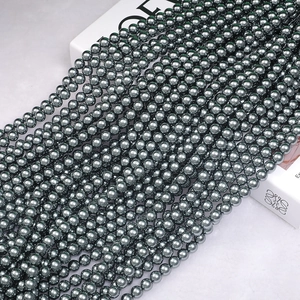Macro shot of dark grey metallic pearls with high luster on a stylish brand display box