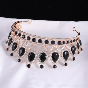 Detail of baroque bridal crown with black teardrop crystals on a golden metal frame