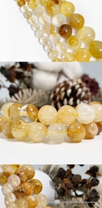 Macro detail of natural golden rutilated quartz beads with needle-like inclusions