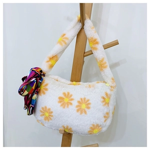 Detail of plush faux fur daisy print bag featuring a colorful silk scarf on handle