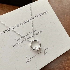 Minimalist S925 sterling silver knotted ring necklace on a white romantic greeting card