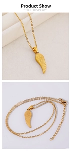 Detailed view of gold feather pendant necklace with O-chain and lobster clasp