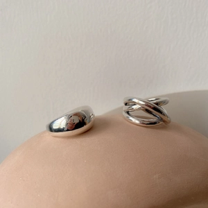 Polished silver minimalist open rings featuring a smooth round band and a multilayered cross design