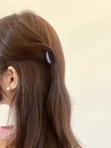 Lavender purple acrylic hair claw clip for half-up hair styling on brown wavy hair