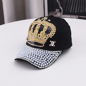 Detail of luxury black baseball cap with gold crown embroidery, pearls and rhinestones