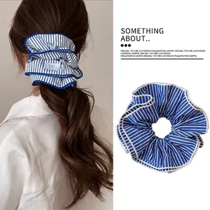 Blue and white striped scrunchie with layered ruffles for a stylish hair ponytail accessory