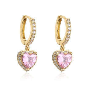 Detailed close-up of gold heart earrings with pink gemstones and pavé zirconia stones